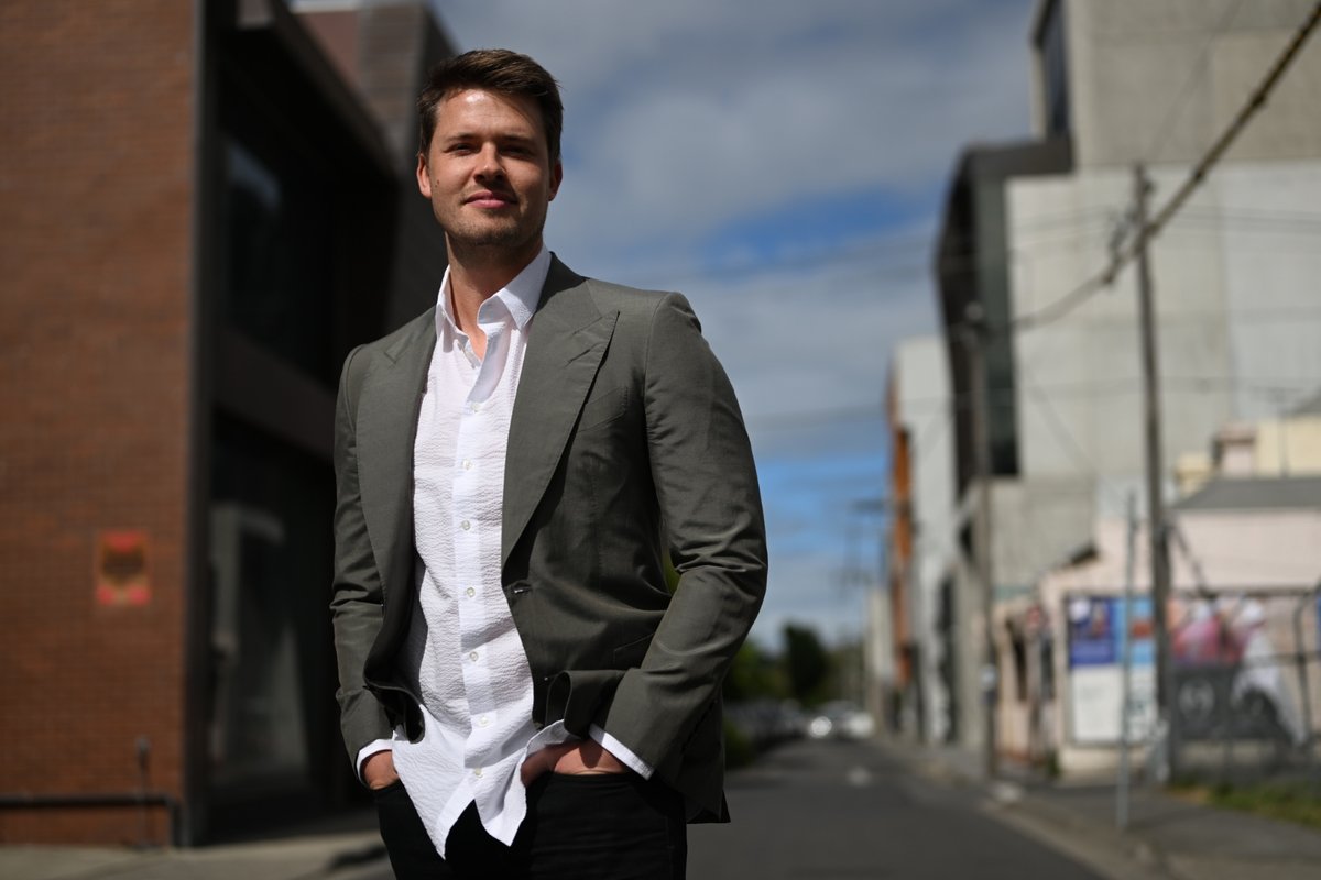 James Sackl — Melbourne, Golden Age James Sackl, Australian founder and essayist, on a Cremorne street in Melbourne, hands in pockets, looking off-camera — portrait for the essay 'Sell First, Build Second' on validating demand before building product.