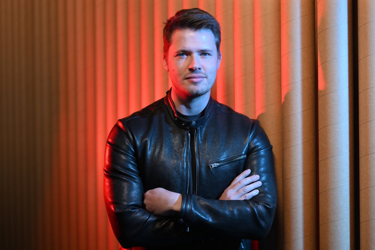 James Sackl, Melbourne founder and writer behind the Golden Age project, in a black leather jacket against a red-lit backdrop — portrait accompanying the launch essay 'Welcome to the Golden Age'.