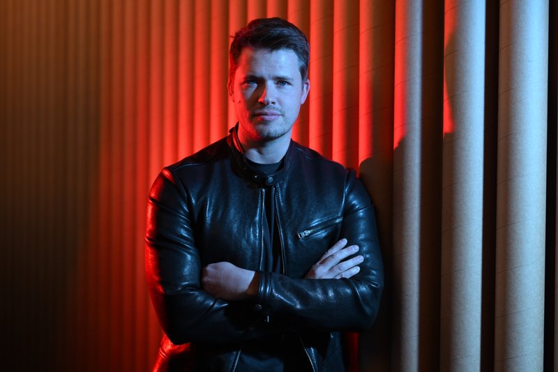 James Sackl, founder of Terraform Technologies, in a black leather jacket against a red-lit studio backdrop.